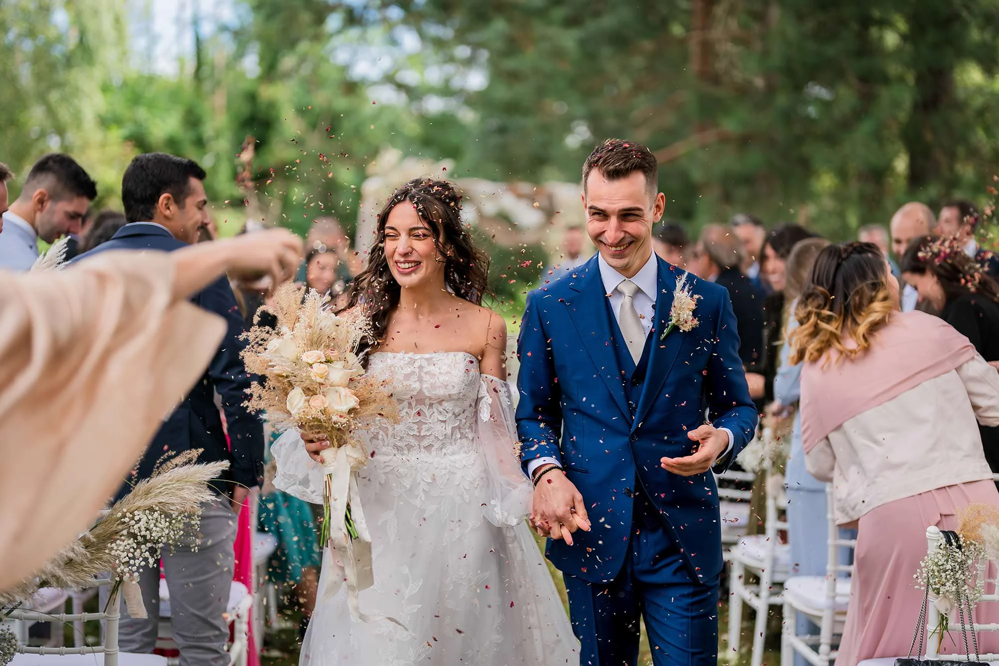 Home Page Simone Goglia 12 Bride and groom walking down the aisle under a shower of rice after the outdoor ceremony
